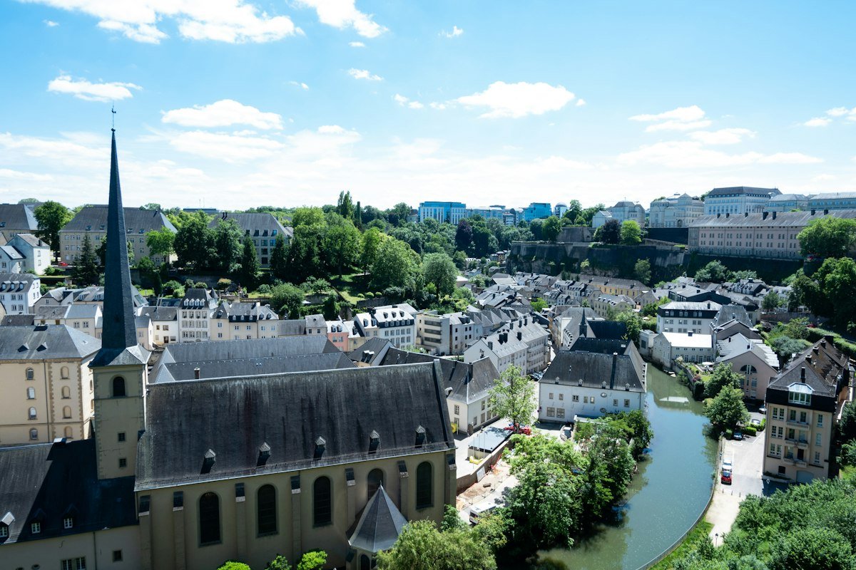 River running through Luxembourg City beside tall buildings