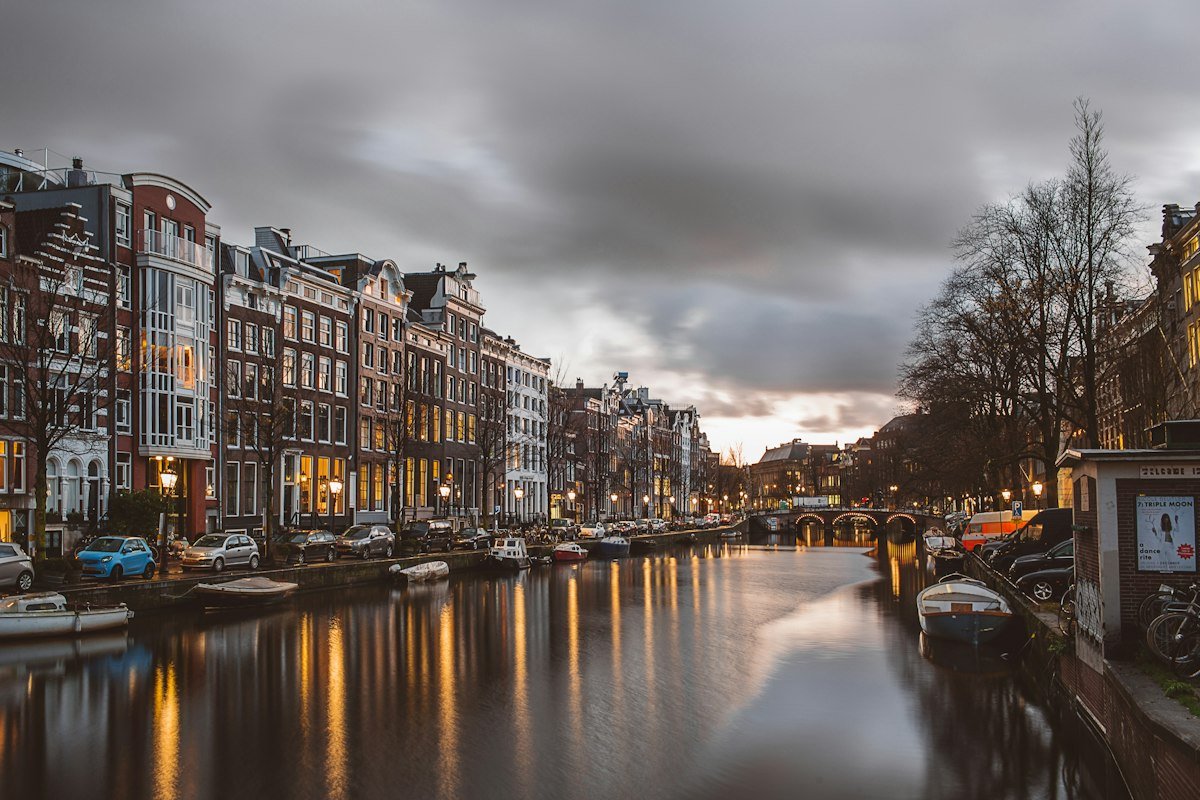 Historic canal houses in Amsterdam at dusk