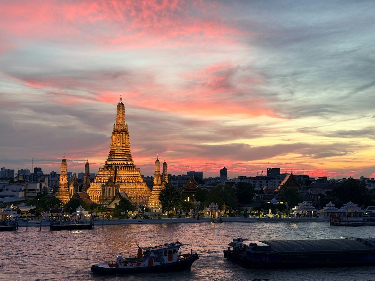Thailand Digital Nomad Visa Wat Arun temple illuminated at sunset in Bangkok